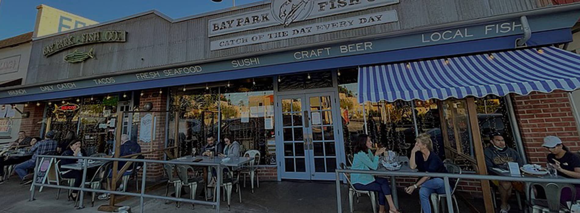 People having lunch at a fish restaurant in Bay Park. Discover homes for sale opportunities in San Diego