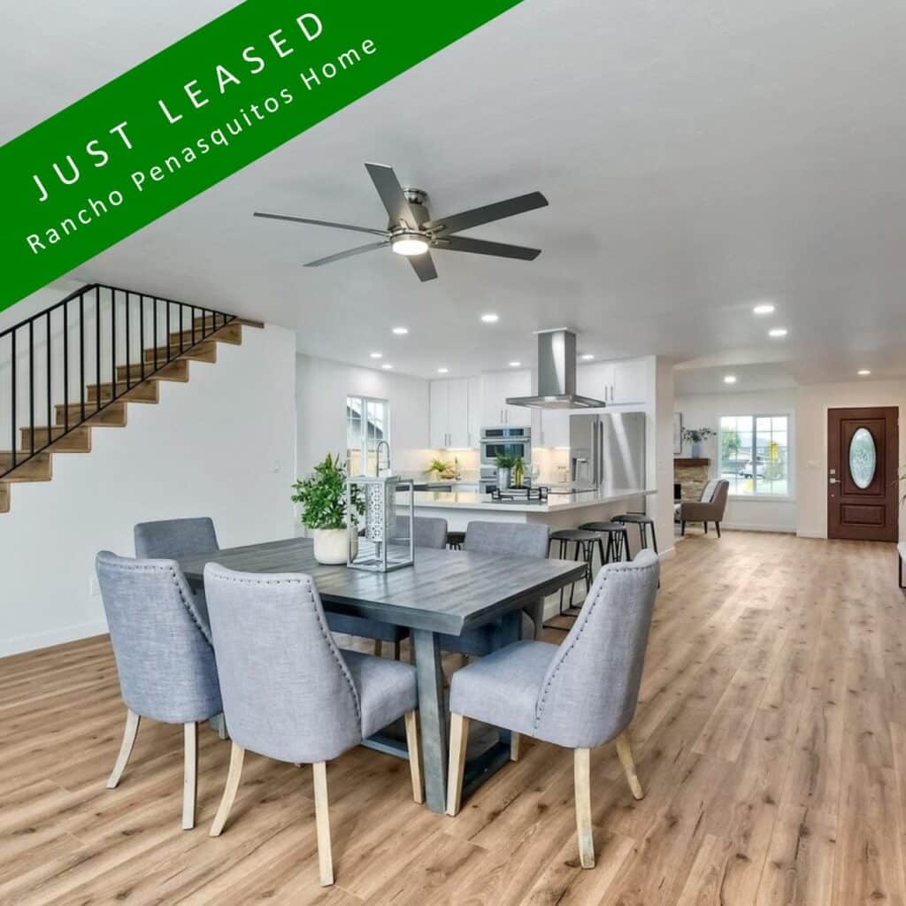 Cozy living room with hardwood floors and ceiling fan in Rancho Penasquitos rental property.