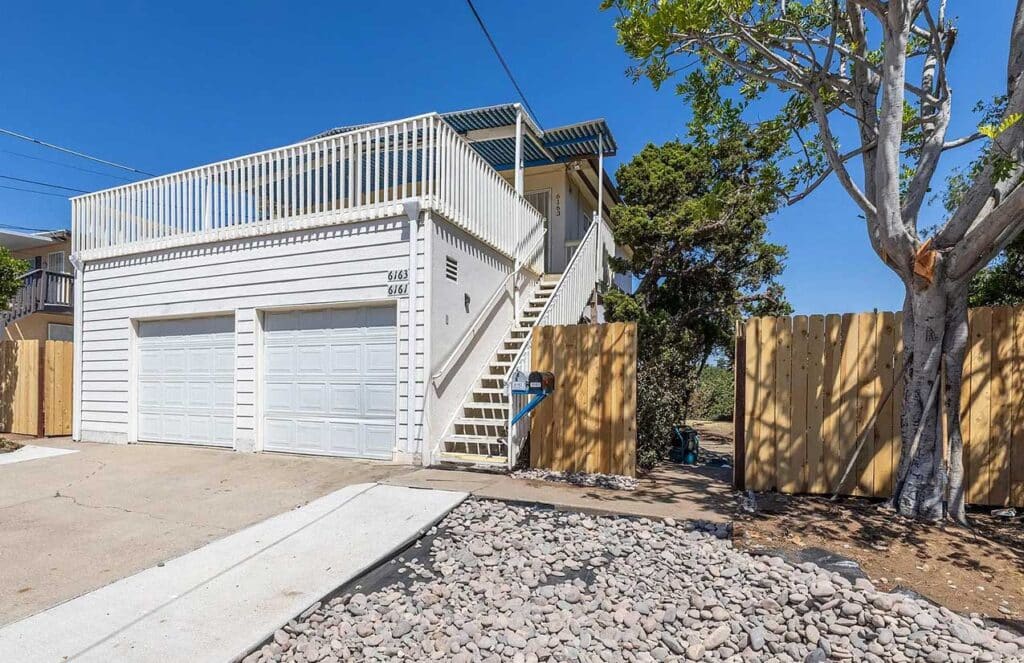 A residential property with a garage and a fence, highlighting a charming and secure environment in La Mesa San Diego.