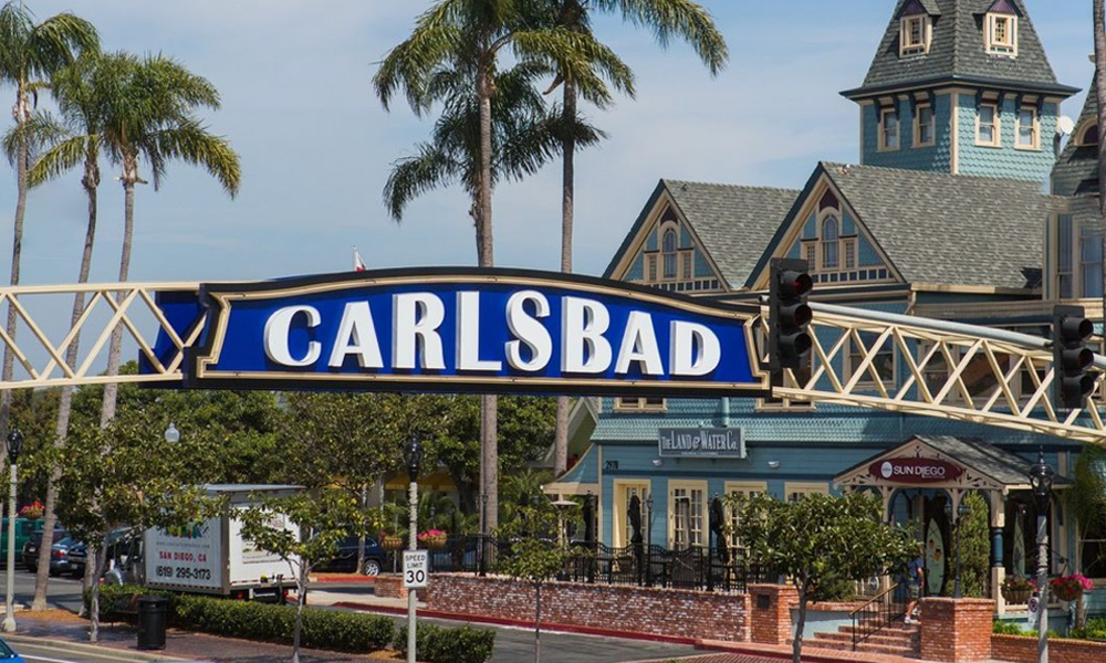 Cars navigate the bustling streets of Carlsbad, CA, showcasing urban life and vibrant city dynamics.