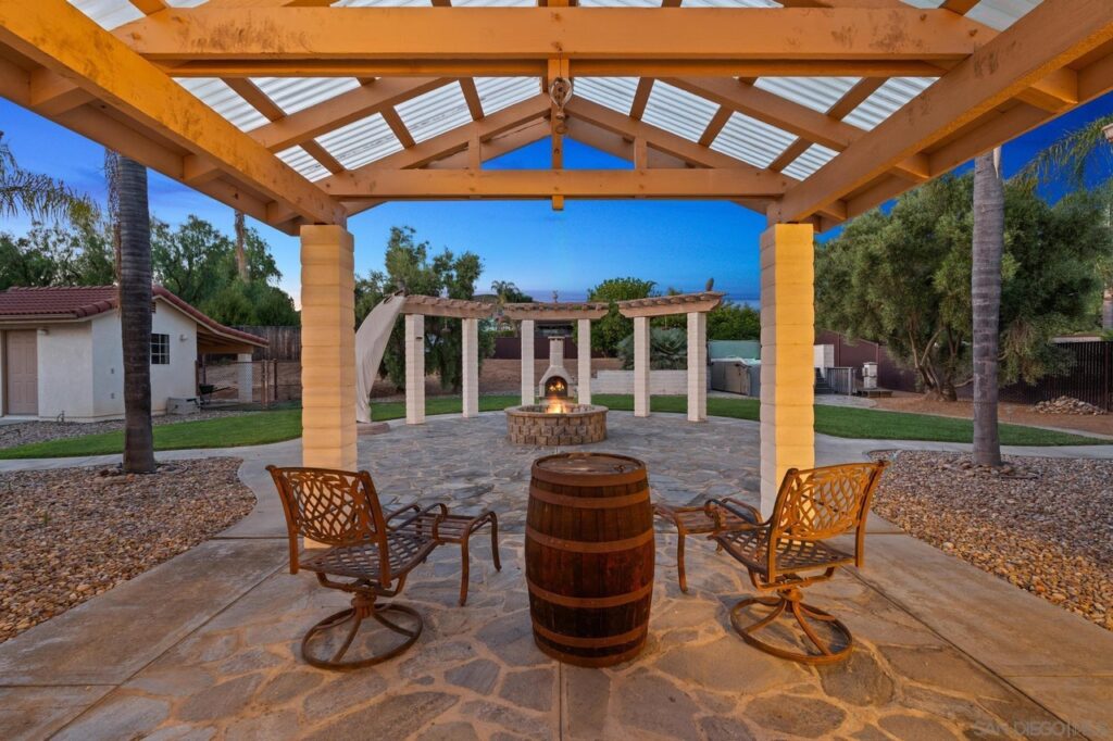 A cozy patio in Ramona, CA, featuring chairs surrounding a fire pit, perfect for relaxation and gatherings.