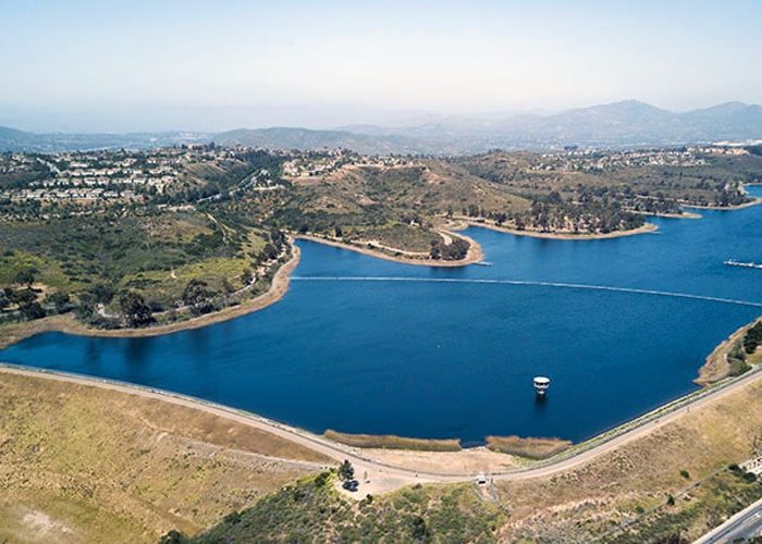 Aerial view of Lake Miramar at Scripps Ranch, showcasing a vast body of water surrounded by lush greenery