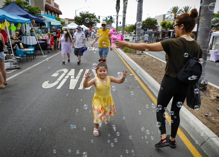 Little girl celebrating at the annual Lemon Festival in Downtown Chula Vista. Discover homes for sale opportunities with the best real estate agents!
