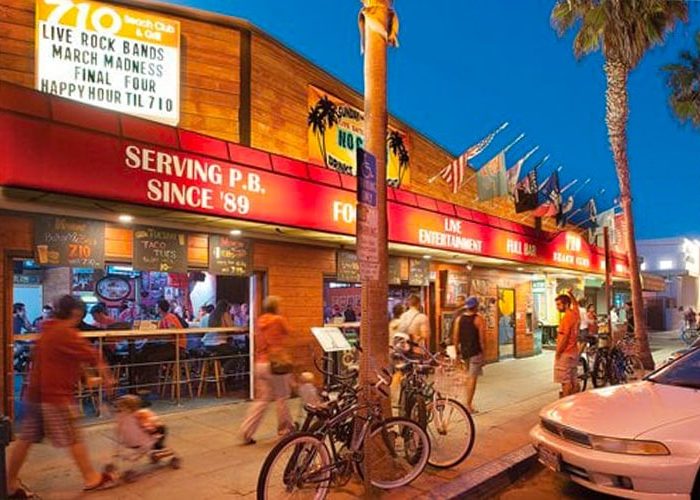 A picturesque street view in San Diego with a charming restaurant and a bike shop, illustrating the lively neighborhood of Pacific Beach