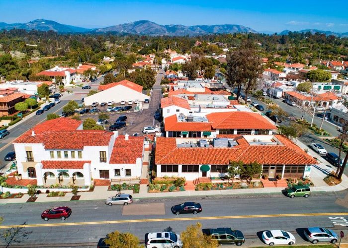Aerial view of Rancho Santa Fe town in California with parked cars lining the streets.