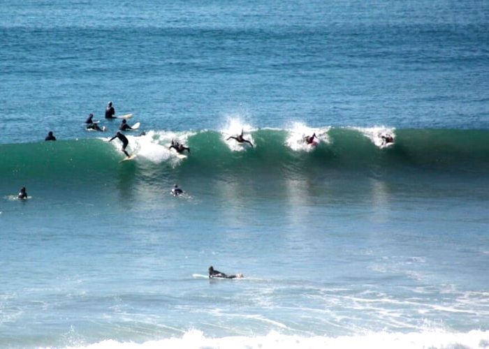 Surfers at Swamis Seaside Park. Discover homes for sale opportunities in Encinitas San Diego