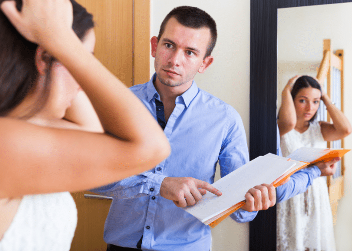 A man holding an eviction sign to a woman looking surprised.