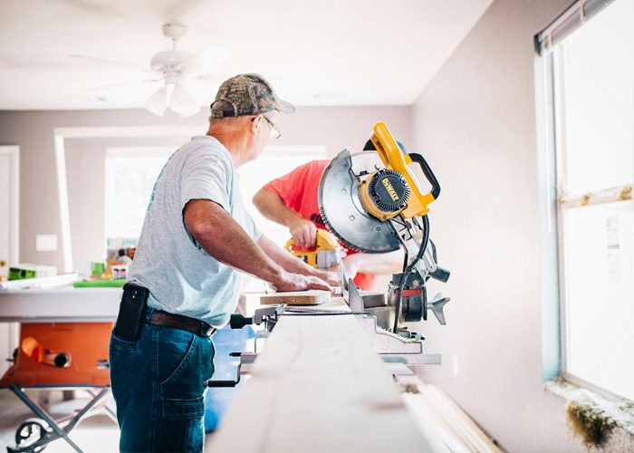 Two people working on some home repairs, as part of the service catalogue of a property manager